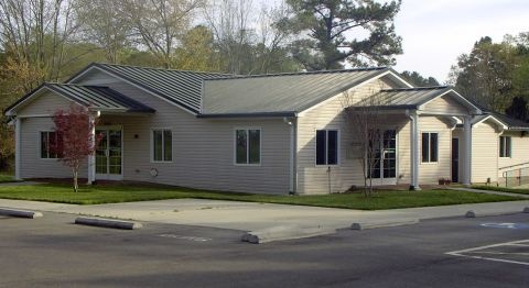 Goldston Public Library, with its green roof and welcoming entrance beneath the trees